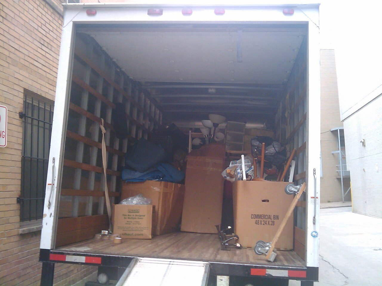 Moving boxes stacked in the back of a moving truck